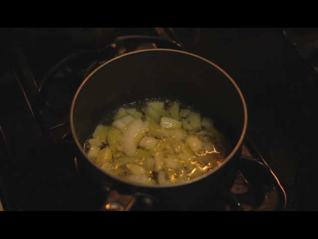 Ein Herd mit einem Gefäß darauf, in dem ein Gegenstand gekocht wird.